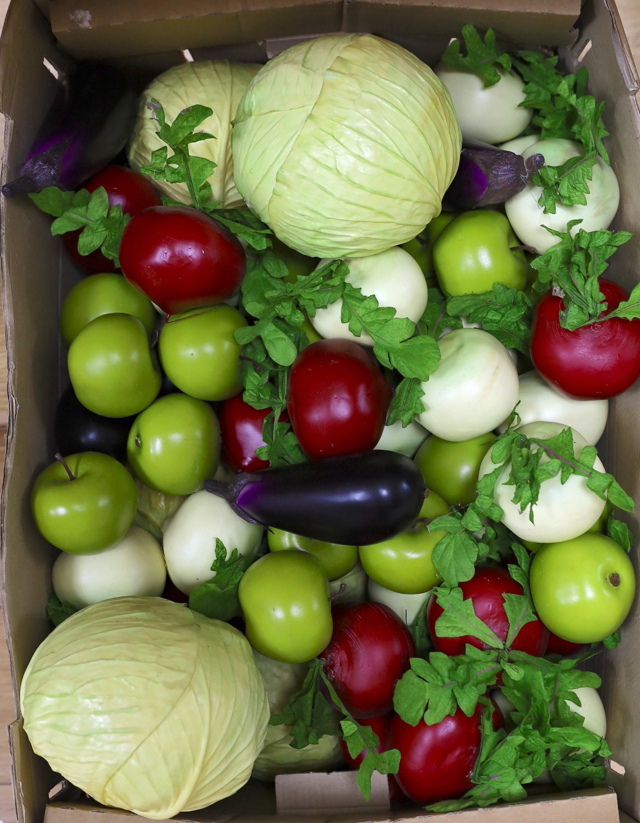 A large quantity of faux fruit